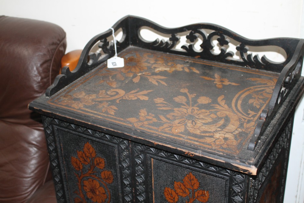 An Edwardian ebonised music cupboard, with floral pokerwork decoration, W.47cm D.35cm H.91cm